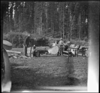 Harry Schmitz and Wilfrid Cline, Jr. stand in their campsite, Siskiyou County, 1917