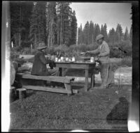 Harry Schmitz and Wilfrid Cline, Jr. eating in camp, Siskiyou County, 1917