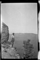Wilfrid Cline, Jr. posing while overlooking a canyon near Kosk Creek, Shasta County, 1917