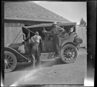 H. H. West standing on the running board of a car, Burney, 1917