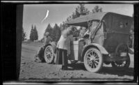 Harry Schmitz fixing a traveler's car while Wilfrid Cline, Jr. watches, Bieber, 1917