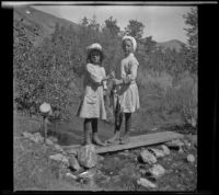Irene Schmitz and an unknown girl posing with fish, June Lake vicinity, 1914