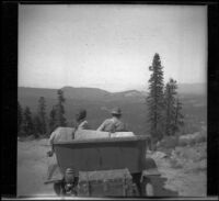 Isabelle Smith and Dave F. Smith sit in their car and look out towards Lake Tahoe, Lake Tahoe vicinity, 1913