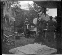 Mary A. West, Nella A. West and Dave F. Smith standing in their campsite at Silver Lake, June Lake vicinity, 1913