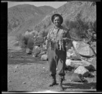 Dave F. Smith posing with the limit of golden trout, Inyo County, 1913