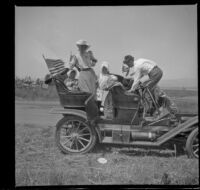 Mary West and Glen Velzy stand in a car with Elizabeth West and Frances West, Tustin, 1909