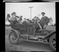 Glen Velzy stands as Bessie Velzy, Mary West, and Elizabeth and Frances West sit in H. H. West's car, Coronado, 1909