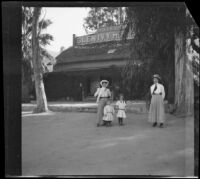 Mary West stands with her daughters, Elizabeth and Frances, and Bessie Velzy in front of the Glen Ivy Hot Springs Hotel, Corona, 1909