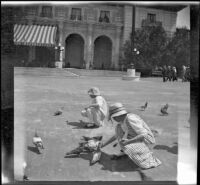 Frances West and Elizabeth West feeding pigeons in the Plaza de Panama at Balboa Park, San Diego, [about 1915]