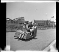 Elizabeth West, Minnie West, Christina Schmitz and Frances Cline riding an Osborn Electriquette through Balboa Park, San Diego, [about 1915]