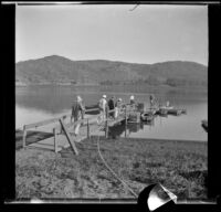 Men walk along a dock at Lake Hodges, San Diego, [about 1930-1931]