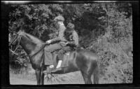H. H. West, Jr. and another boy riding on horseback, San Dimas, about 1929