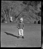 H. H. West, Jr. standing in the canyon, San Francisquito Canyon, about 1922