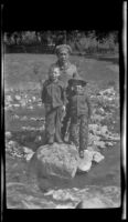 H. H. West, Jr., Keyo and Ambrose Cline standing atop rocks and posing in a stream, San Francisquito Canyon, about 1923