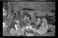 Members of the West, Schmitz and Lemberger families taking a break to dine by the side of their car, San Francisquito Canyon, [about 1917]