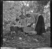 Will P. Mead, Mary A. West and Sena Mead gathered near their camp table, San Gabriel Canyon, about 1903