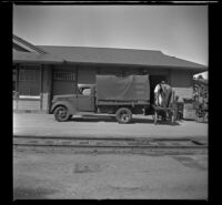 Men unload luggage from a truck at the Southern Pacific Railroad depot, San Luis Obispo, 1942