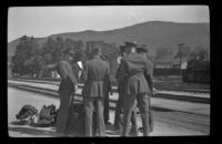H. H. West Jr. stands by the tracks at the Southern Pacific Railroad depot with other soldiers, San Luis Obispo, 1942
