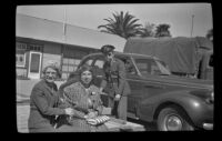 Mertie West sits on a wooden platform with Elizabeth West Siemsen while H. H. West Jr. stands behind, San Luis Obispo, 1942