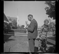 Wayne West stands on his front lawn with his mother-in-law, Anna Pike Foreman, Santa Ana, 1937