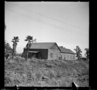Santa Ana Gun Club house with palm trees and windmill nearby, Santa Ana, 1937