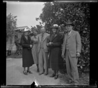 Mertie Whitaker West and other members of H. H. West's family stand in front of an orange tree by Wayne West's home, Santa Ana, 1940