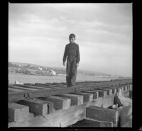 Richard Siemsen poses on the trestle, Newport Beach, 1941