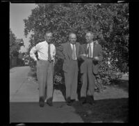 Wayne West, H. H. West, and Evert West stand in front of an orange tree in Wayne West's yard, Santa Ana, 1941