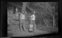 Glen Velzy and H. H. West carry their gear as they leave Glen Velzy's cabin, San Gabriel Mountains, 1941