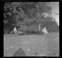 Al Schmitz standing by his Buick Runabout in the campsite, Santa Ynez River vicinity, 1919