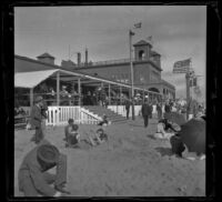 North Beach Bath House with people on the beach and the patio, Santa Monica, about 1895
