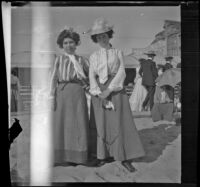 Lizzie Chandler and Nettie Davies stand in the sand, Santa Monica, 1901