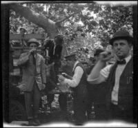 Rubber Men's Picnic attendees line up at the beer keg, Santa Monica Canyon, about 1908