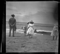 People standing on the beach, Santa Monica, about 1920