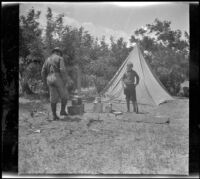 Al Schmitz and Wilfrid Cline, Jr. stand in their campsite along Taboose Creek, Big Pine vicinity, about 1917
