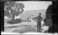 Frank Beckett stands by the Chevrolet during a stop in Lebec, Gorman vicinity, about 1923
