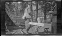 Al Schmitz gathers up his fishing gear, Tuolumne Meadows, about 1922