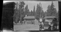 H. H. West's Chevrolet Baby Grand passes by a park checking station, Yosemite National Park, abour 1923