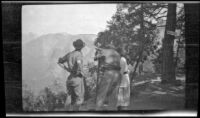 Frank Beckett, Wilfrid Cline, Jr. and Elizabeth West look out over Yosemite Valley from Inspiration Point, Yosemite National Park, about 1923