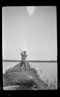 Frank Mellus aims to shoot a duck overhead, Seal Beach vicinity, 1916