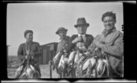 Frank Mellus, Beecher Laswell, John Masters and Walter Morosco pose with ducks, Seal Beach vicinity, 1920