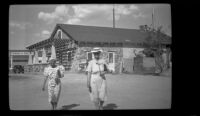 Mertie West and Agnes Whitaker walk by a rest stop, Little Lake, 1940