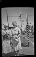 Mertie West and Agnes Whitaker stand on a street corner, Bishop, 1940