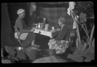 Agnes Whitaker and Mertie West sit at a table at Rock Creek, Mammoth Lakes vicinity, 1940