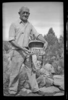Forrest Whitaker displays the trout he caught while fishing, Mammoth Lakes vicinity, 1940
