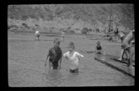 Ambrose Cline and H. H. West, Jr. wade in the lagoon, Topanga, about 1922