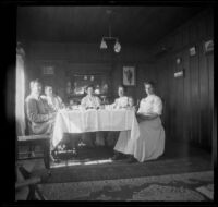 Mary West sits at her dining room table with her daughter, brother-in-law, cousin, and maid, Venice, about 1903