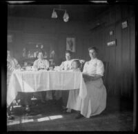 Mary West sits at her dining room table with her daughter, brother-in-law, cousin, and maid, Venice, about 1903