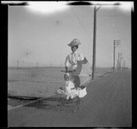 Lola Bidwell pushes Elizabeth West in a stroller, Venice, about 1903