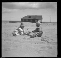 Elizabeth West and Wilfrid Cline Jr. play in the sand, Venice, about 1903